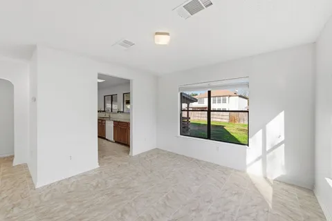 an empty room with windows and closet