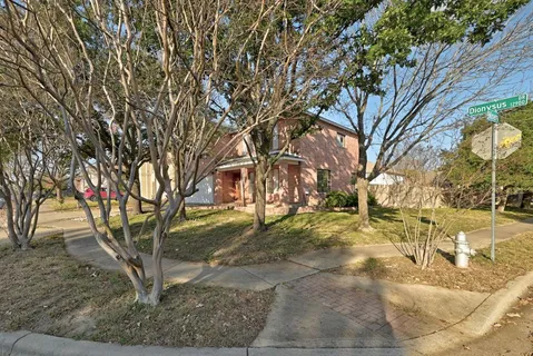 a view of a yard with large trees
