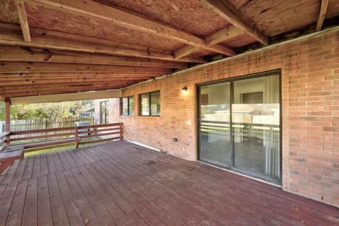 a view of empty room with wooden floor and outdoor space