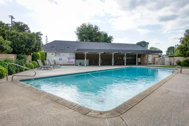 a view of a house with swimming pool and porch