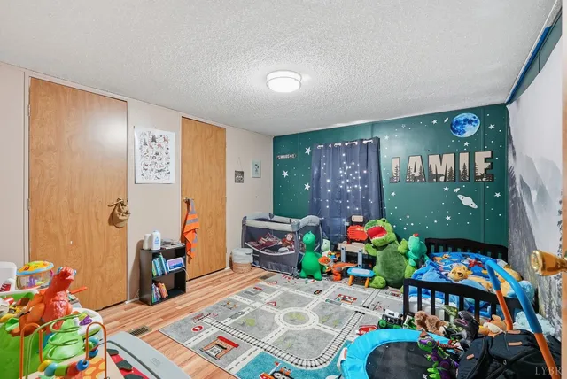 a bedroom with baby toys and dresser