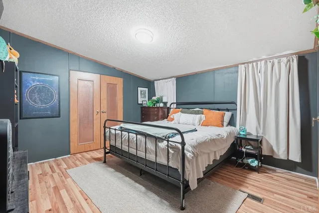 a bedroom with a bed lamp and a window