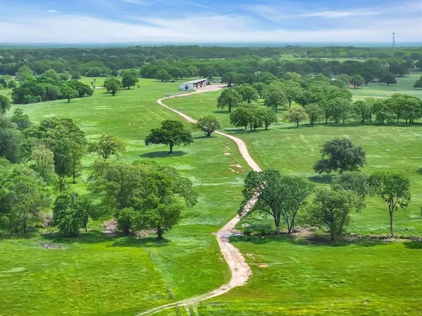 a view of a grassy field with grass and trees