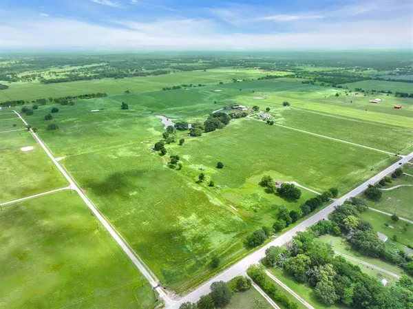 a view of a green field with an outdoor space