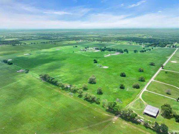 a view of a field with an ocean