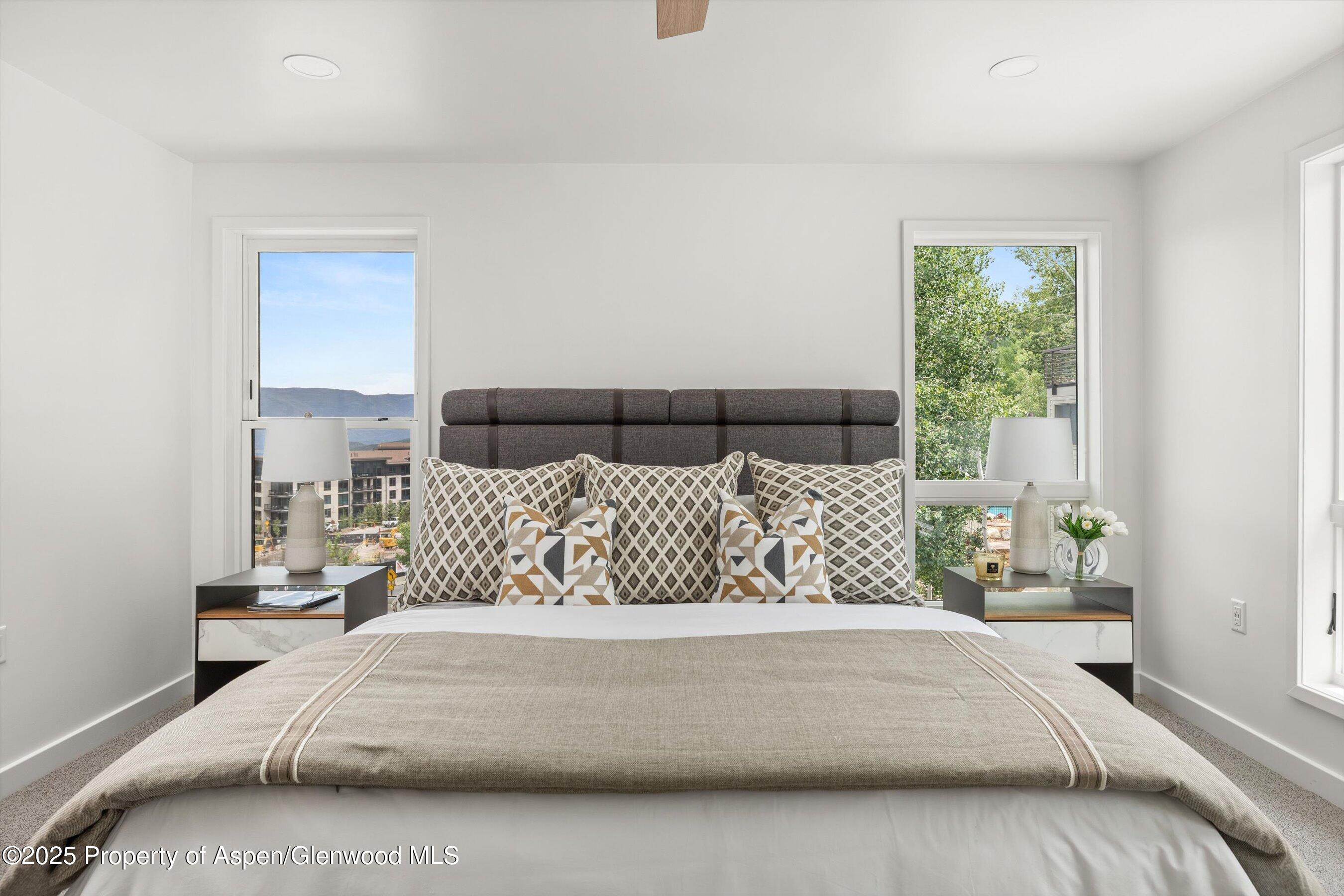 360 Wood Road, Unit 504 Snowmass Village, CO 81615 - Photo 12 of 22 a large bed sitting in a bedroom next to a window