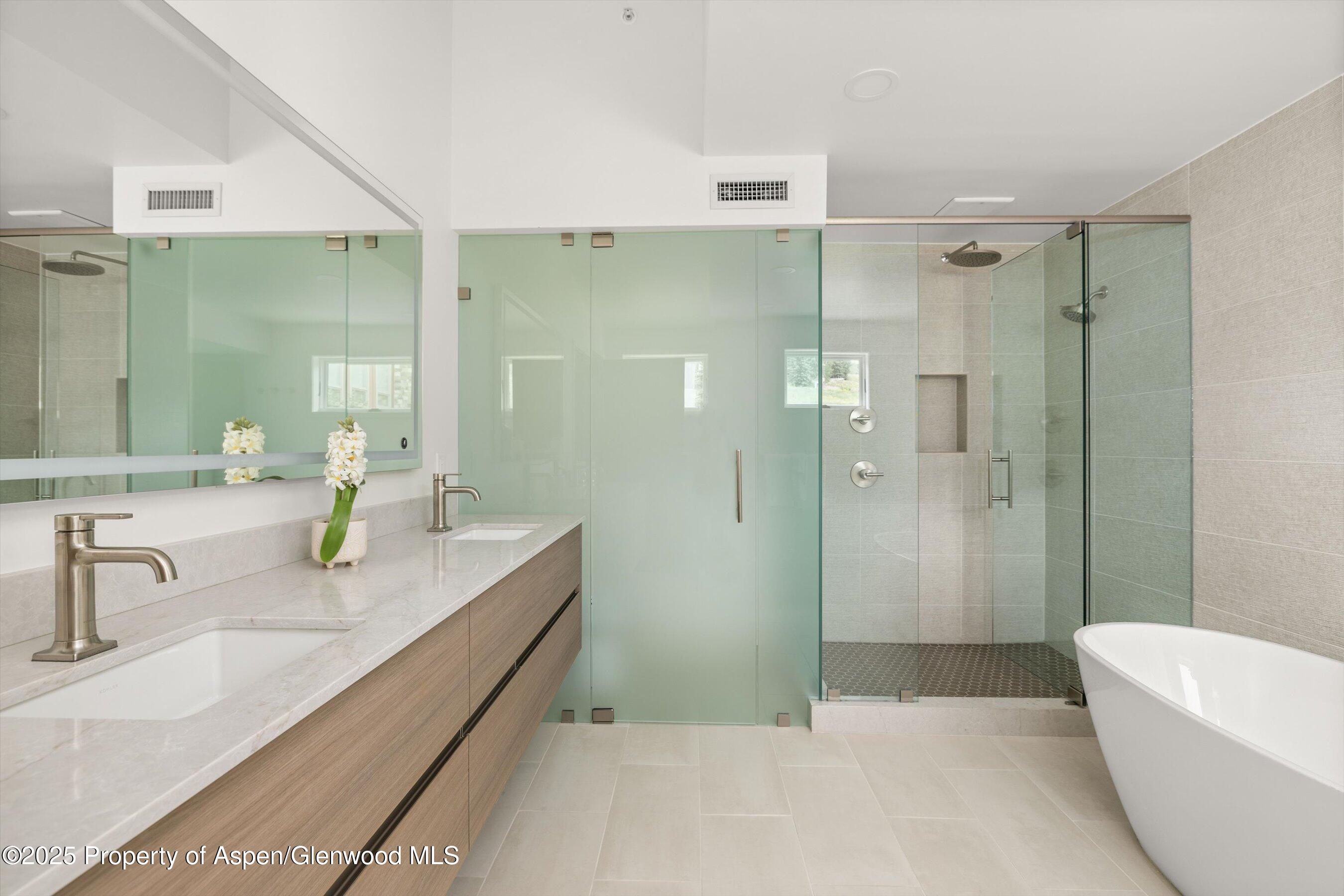 360 Wood Road, Unit 504 Snowmass Village, CO 81615 - Photo 13 of 22 a bathroom with a tub sink and mirror
