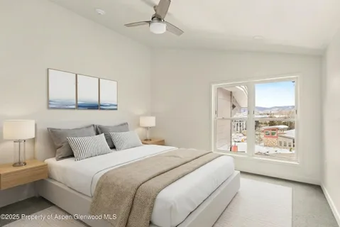 a bedroom with a large bed and a window