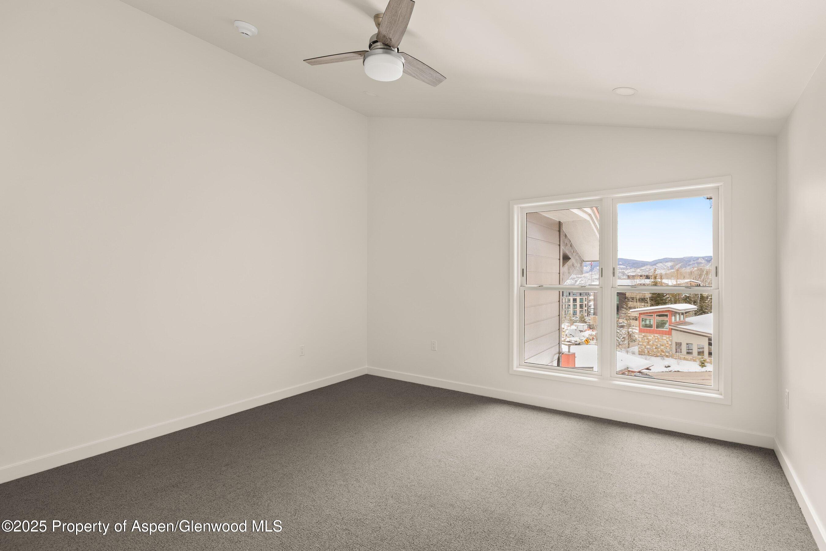 360 Wood Road, Unit 504 Snowmass Village, CO 81615 - Photo 18 of 23 an empty room with windows