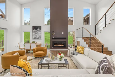 a living room with furniture fireplace and a fireplace