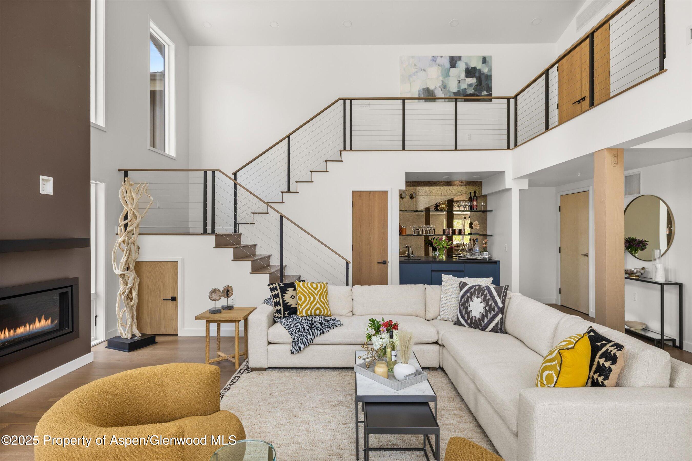 360 Wood Road, Unit 504 Snowmass Village, CO 81615 - Photo 5 of 22 a living room with furniture and a fireplace
