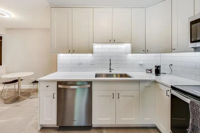 a kitchen with a sink cabinets and appliances