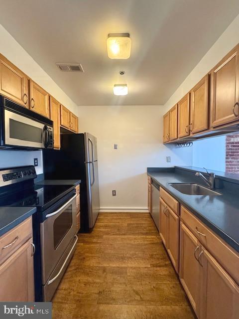 315 New Street, Unit 120 Philadelphia, PA 19106 - Photo 4 of 10 a kitchen with stainless steel appliances granite countertop a stove a sink and a microwave
