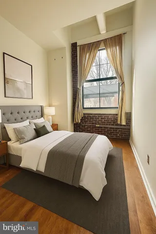 a bedroom with bed and window