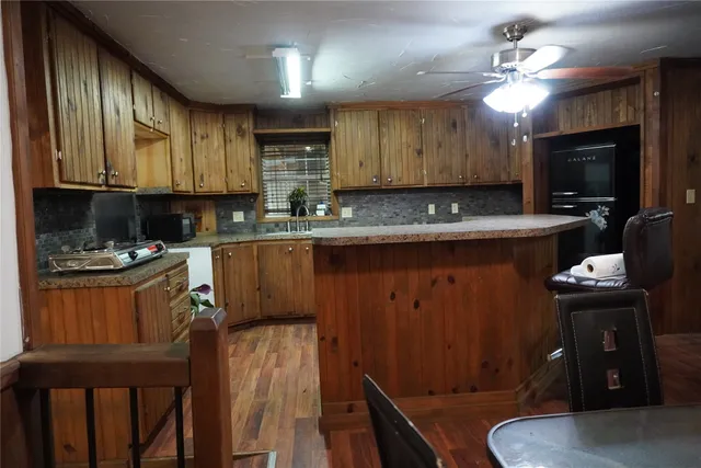 a kitchen with a sink refrigerator and cabinets