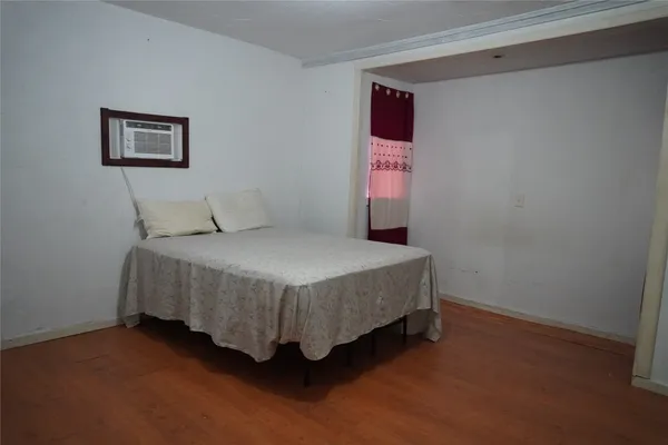 a bedroom with a bed and a wall painting