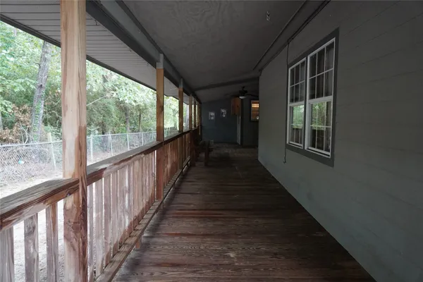 a view of a porch with wooden floor and stairs