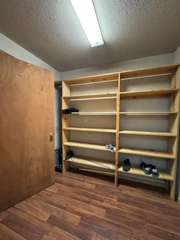 a view of room with wooden floor and a window