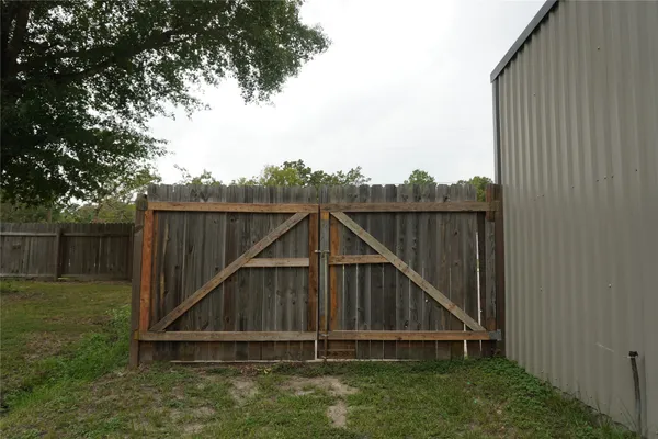 a wooden fence with a small yard