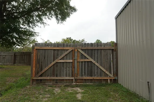 a wooden fence with a small yard