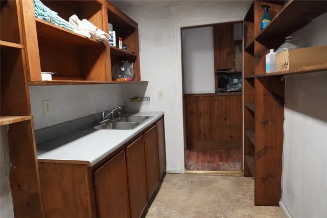 a kitchen with a sink and a refrigerator