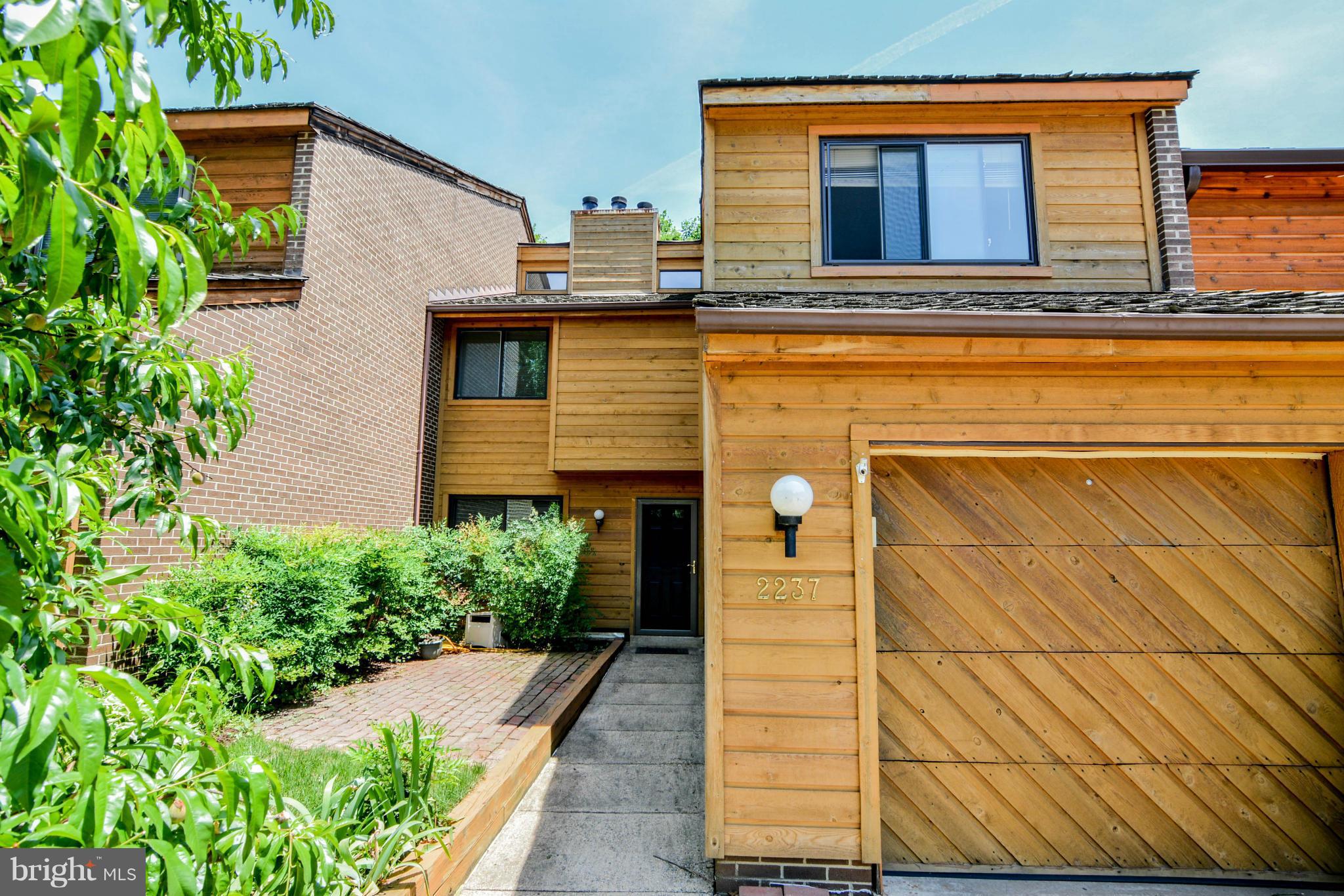 2237 Cedar Cove Court Reston, VA 20191 - Photo 1 of 27 a view of a house with large windows and plants