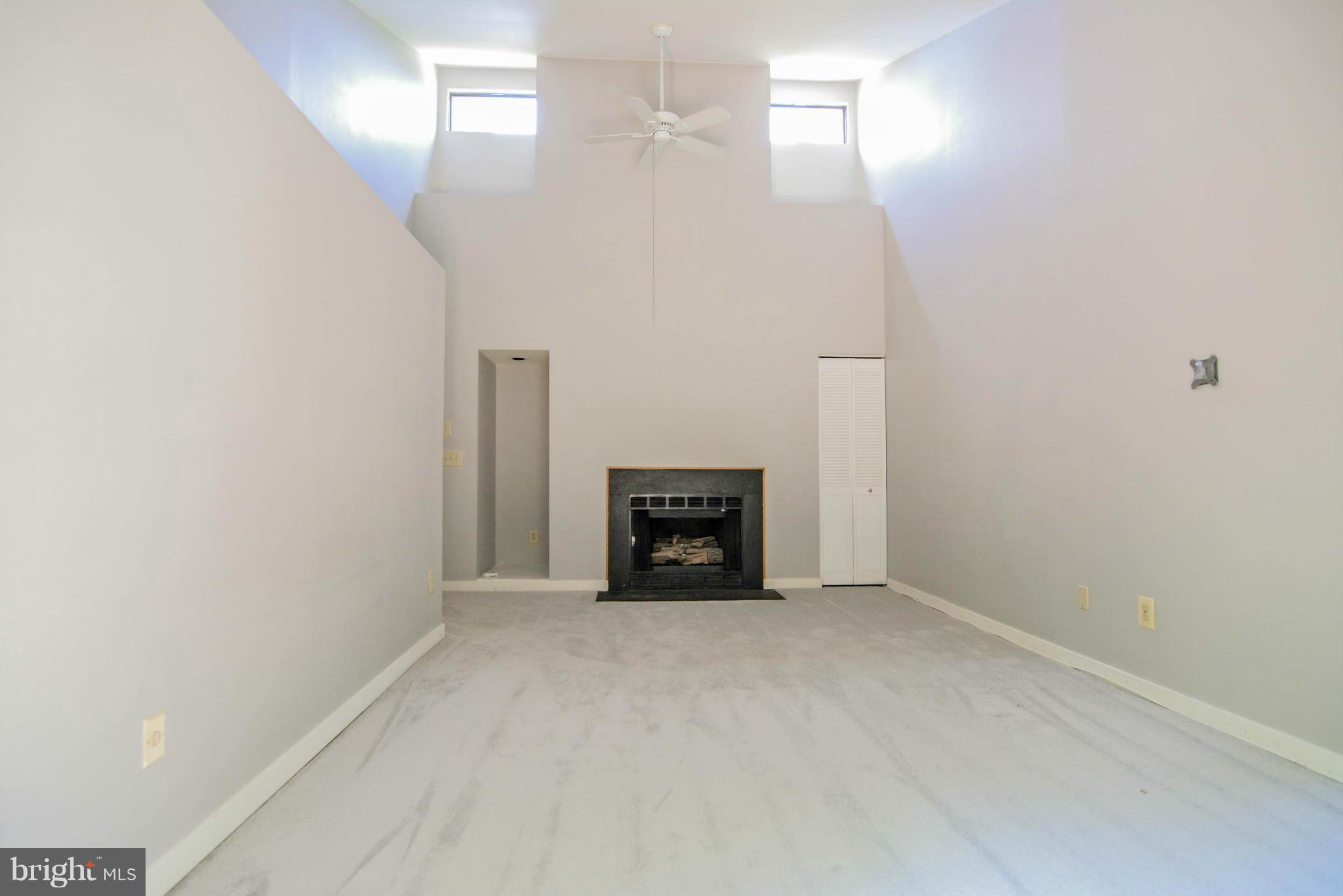 2237 Cedar Cove Court Reston, VA 20191 - Photo 13 of 27 a view of an empty room with a fireplace and a chandelier fan