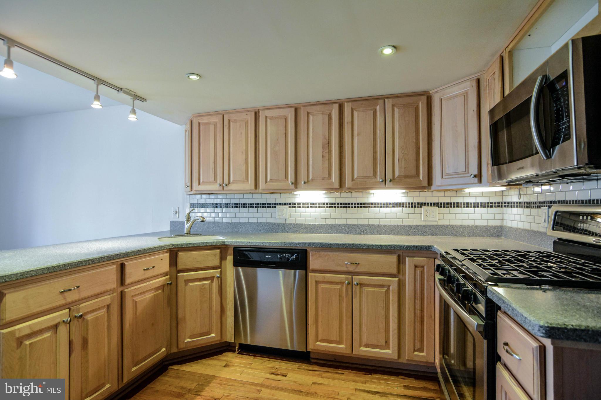 2237 Cedar Cove Court Reston, VA 20191 - Photo 5 of 27 a kitchen with granite countertop a stove sink and cabinets