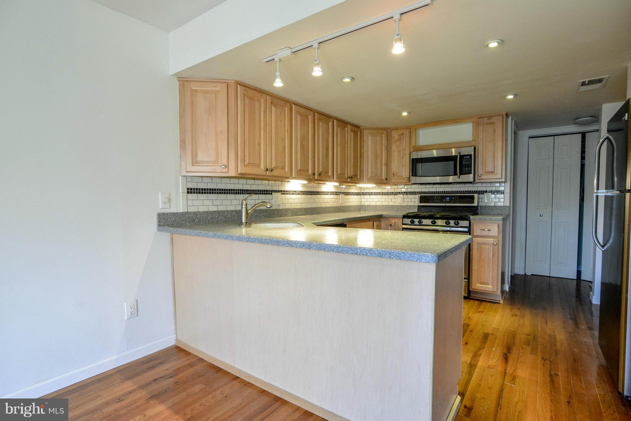 2237 Cedar Cove Court Reston, VA 20191 - Photo 6 of 27 a kitchen with wooden cabinets and stainless steel appliances