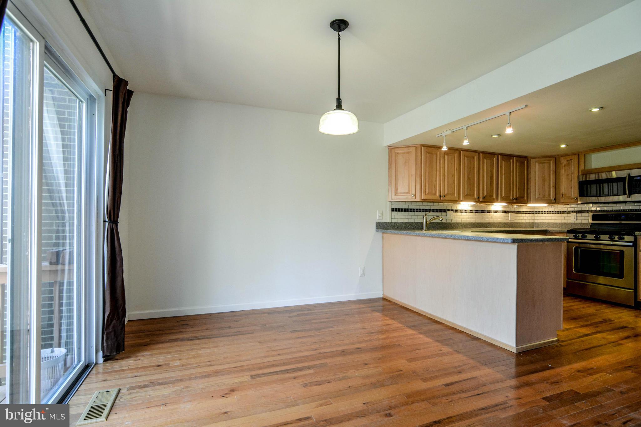 2237 Cedar Cove Court Reston, VA 20191 - Photo 7 of 27 a kitchen with kitchen island a counter space a sink and cabinets