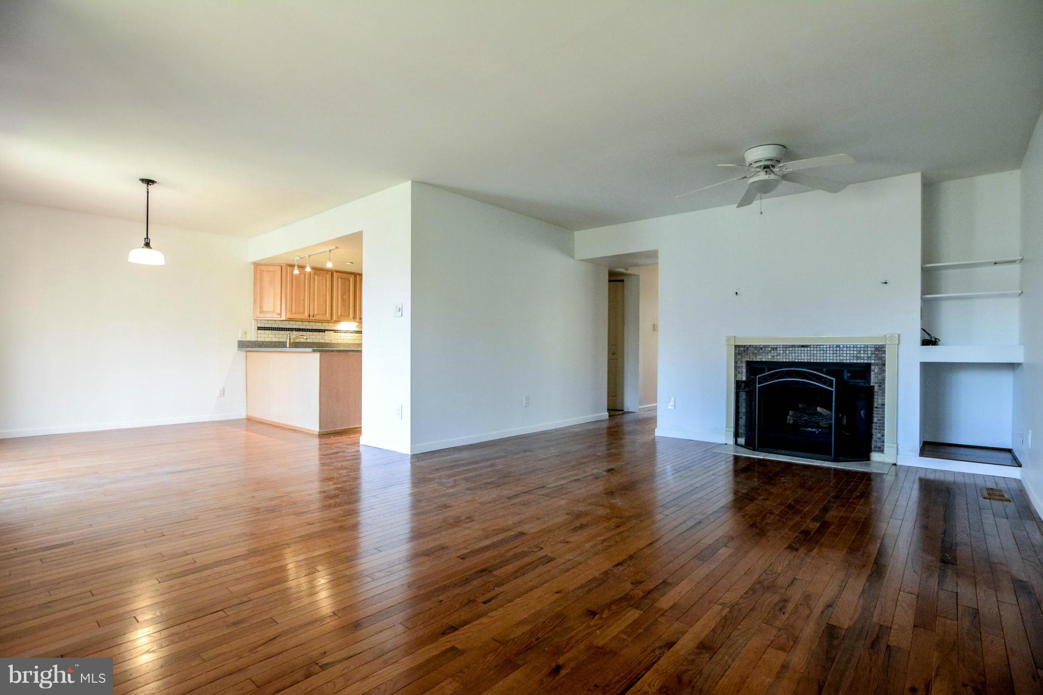 2237 Cedar Cove Court Reston, VA 20191 - Photo 9 of 27 an empty room with wooden floor a fireplace and windows