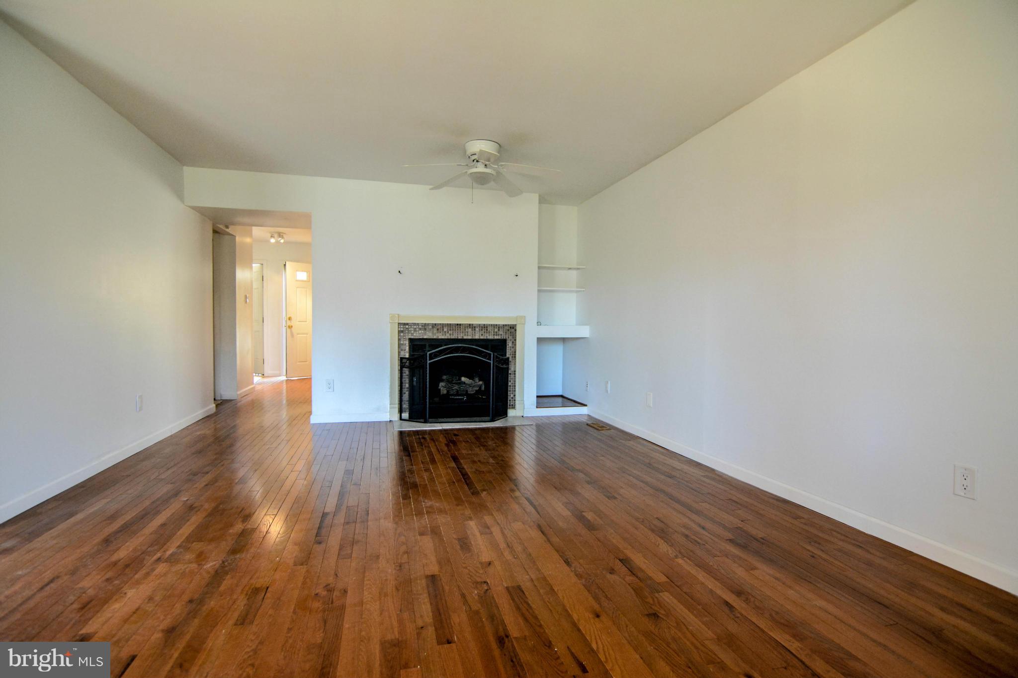 2237 Cedar Cove Court Reston, VA 20191 - Photo 10 of 27 an empty room with wooden floor and a fireplace