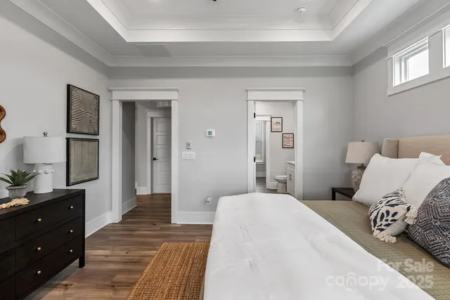 a bedroom with a large bed and a dresser