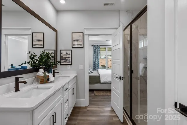 a bathroom with a double vanity sink and a mirror
