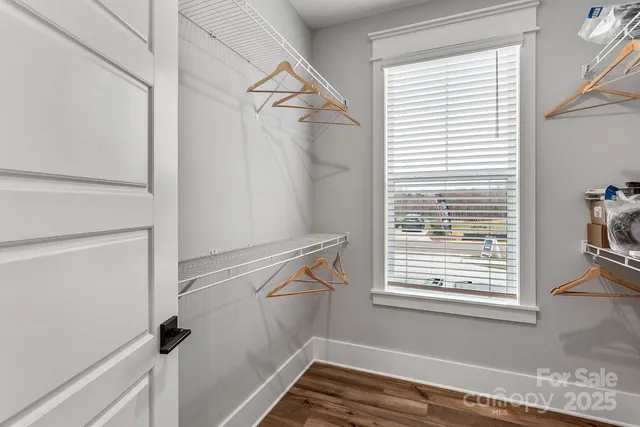 a view of a room with rack on the wall and a window