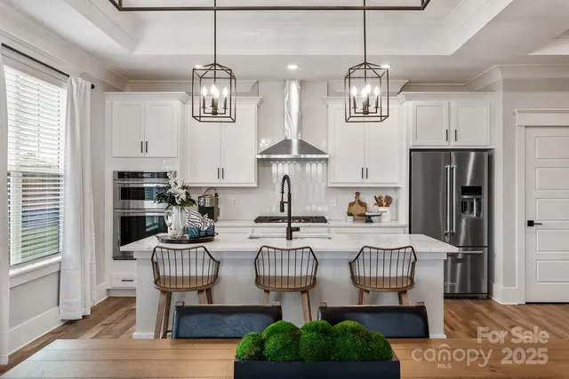 a view of kitchen and dining area with furniture window and wooden floor