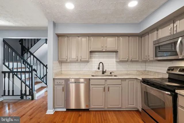 a kitchen with a sink stove and refrigerator