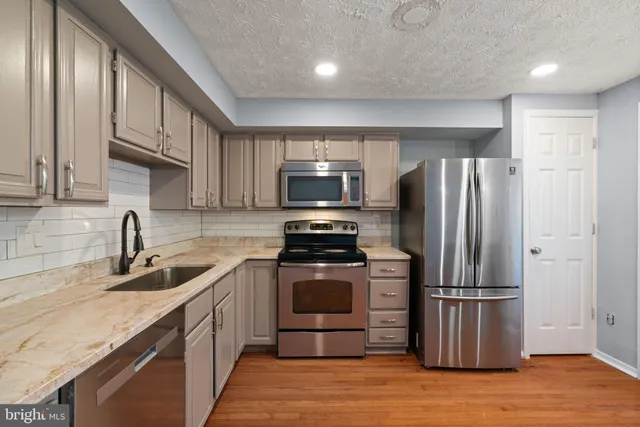 a view of a room with a window and wooden floor