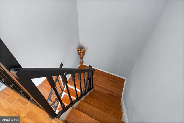 a view of a big room with windows and chandelier