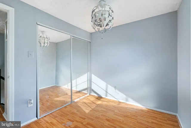 a view of a room that has a bed and a window in it