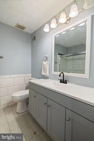 a bathroom with a toilet a sink and shower
