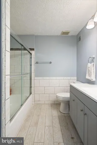 a view of empty room with wooden floor and window