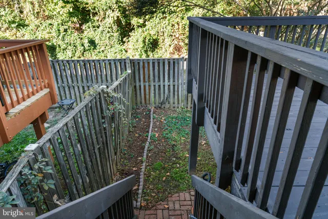 a view of a house with a small yard and a large tree