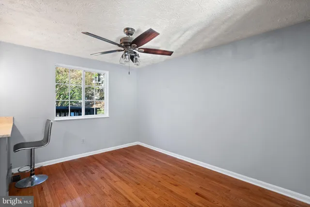 a kitchen with kitchen island a counter top space a sink stainless steel appliances and cabinets