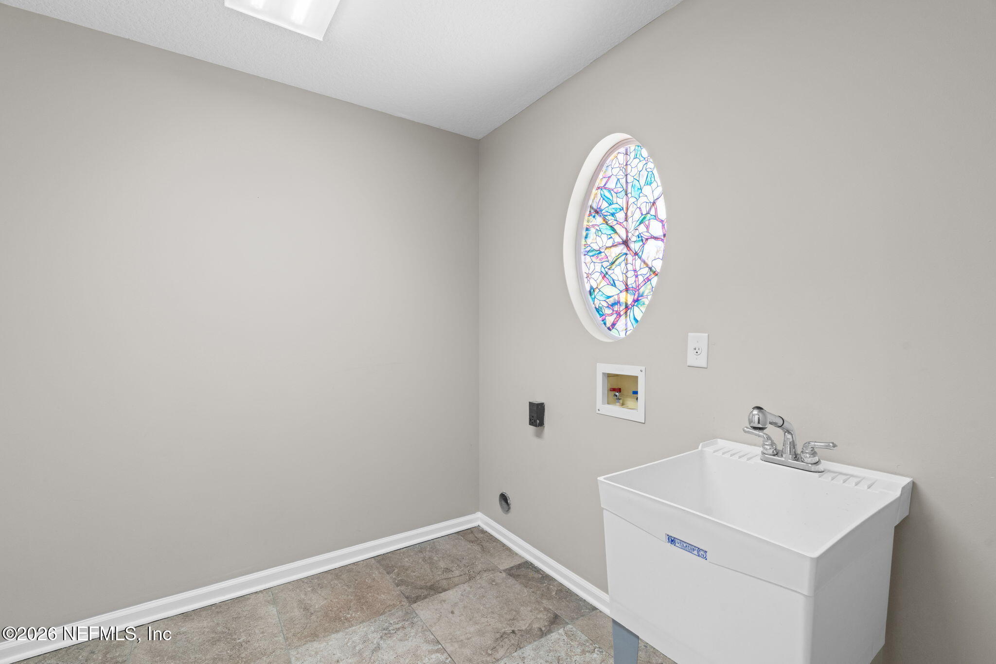 1600 Spring Water Court Fleming Island, FL 32003 - Photo 46 of 85 a bathroom with a sink a vanity and a window