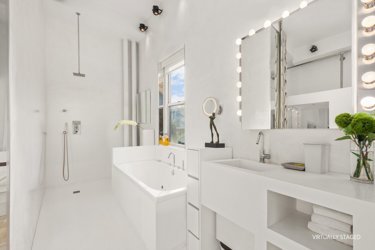400 East 52nd Street, Unit PHTOWER Manhattan, NY 10022 - Photo 14 of 23 a bathroom with a sink and a mirror with bathtub