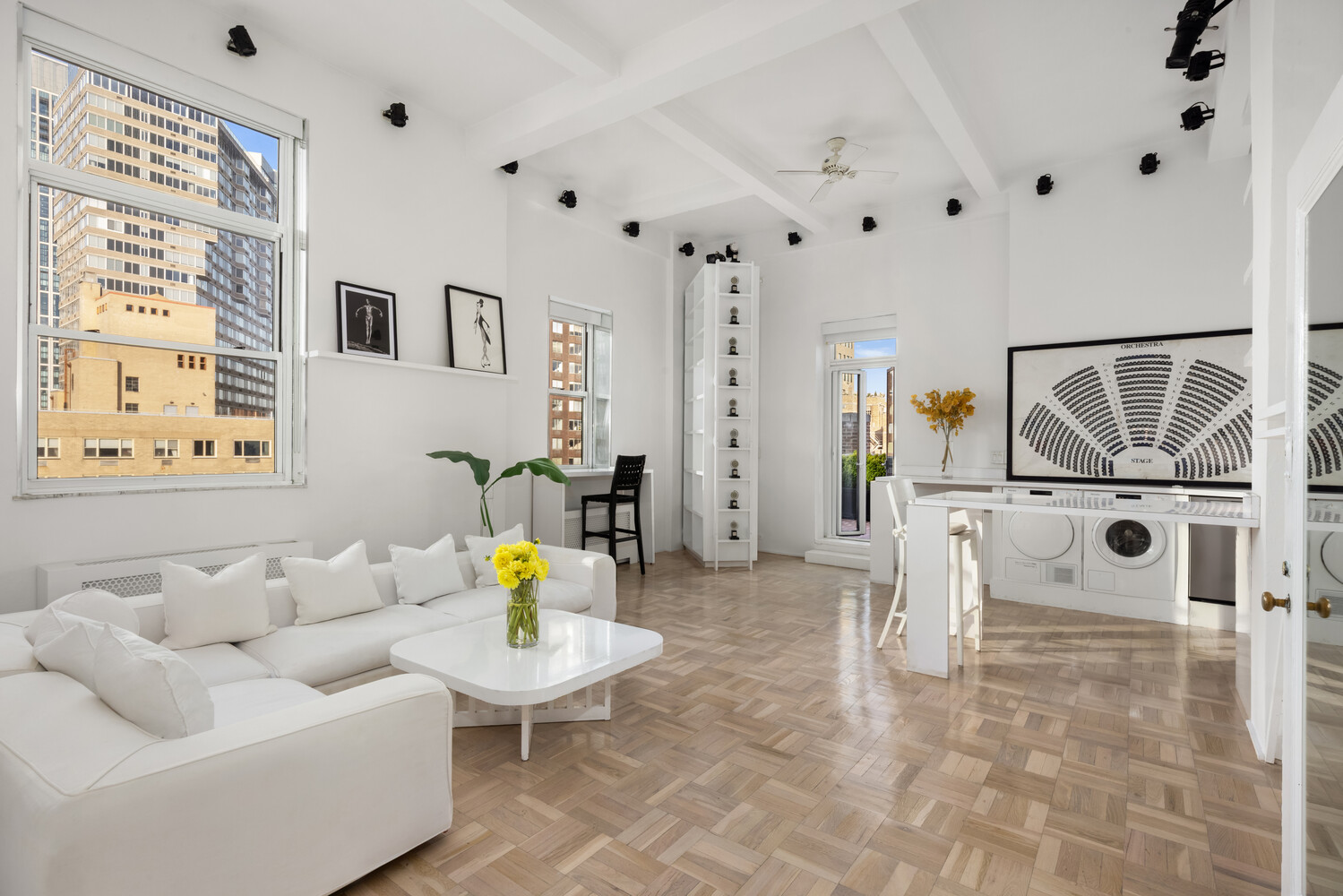 400 East 52nd Street, Unit PHTOWER Manhattan, NY 10022 - Photo 2 of 23 a living room with furniture and a chandelier