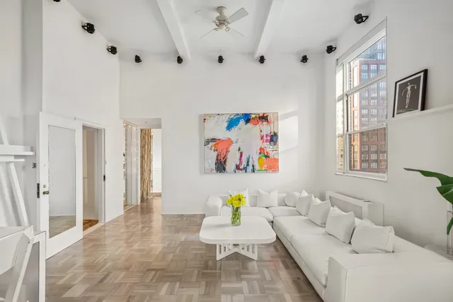 a living room with furniture and wall paintings
