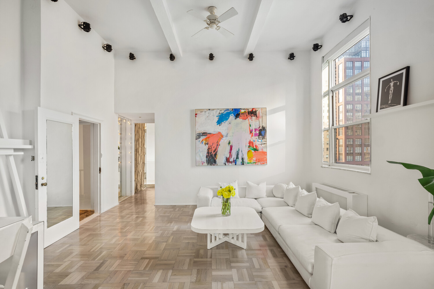 400 East 52nd Street, Unit PHTOWER Manhattan, NY 10022 - Photo 5 of 23 a living room with furniture and wall paintings