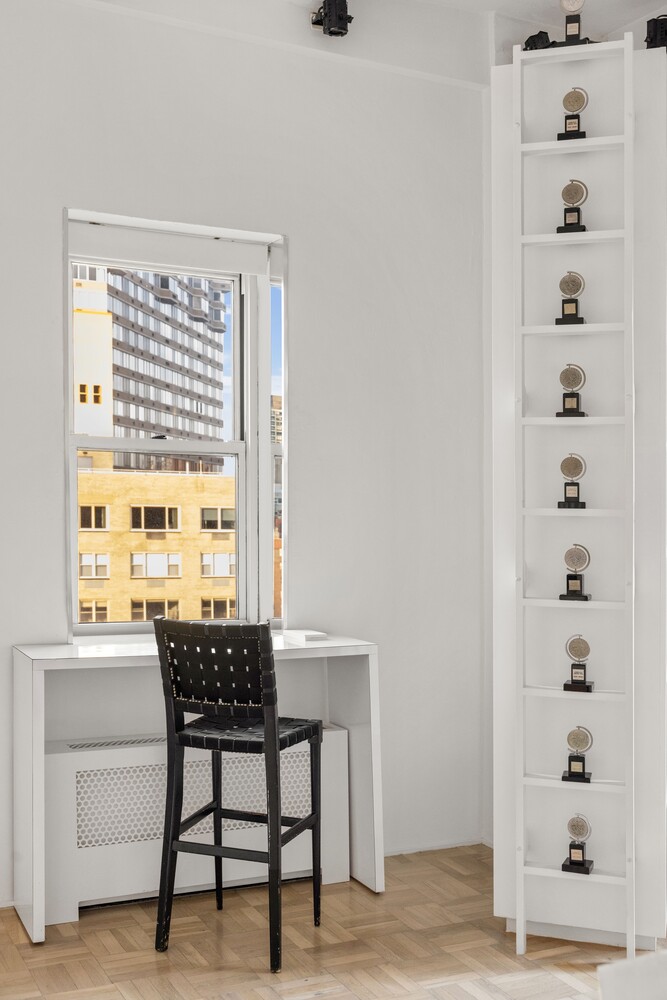 400 East 52nd Street, Unit PHTOWER Manhattan, NY 10022 - Photo 6 of 23 a view of a workspace with furniture and a window